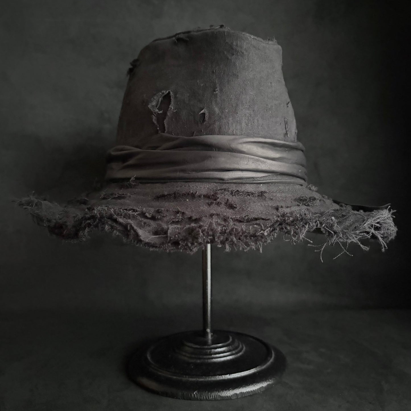 Black linen damage around fedora hat