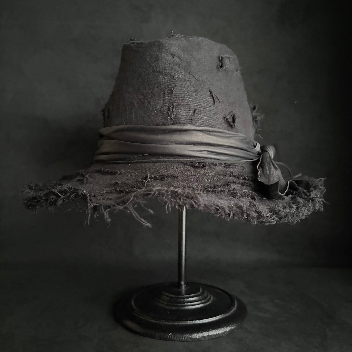 Black linen damage around fedora hat