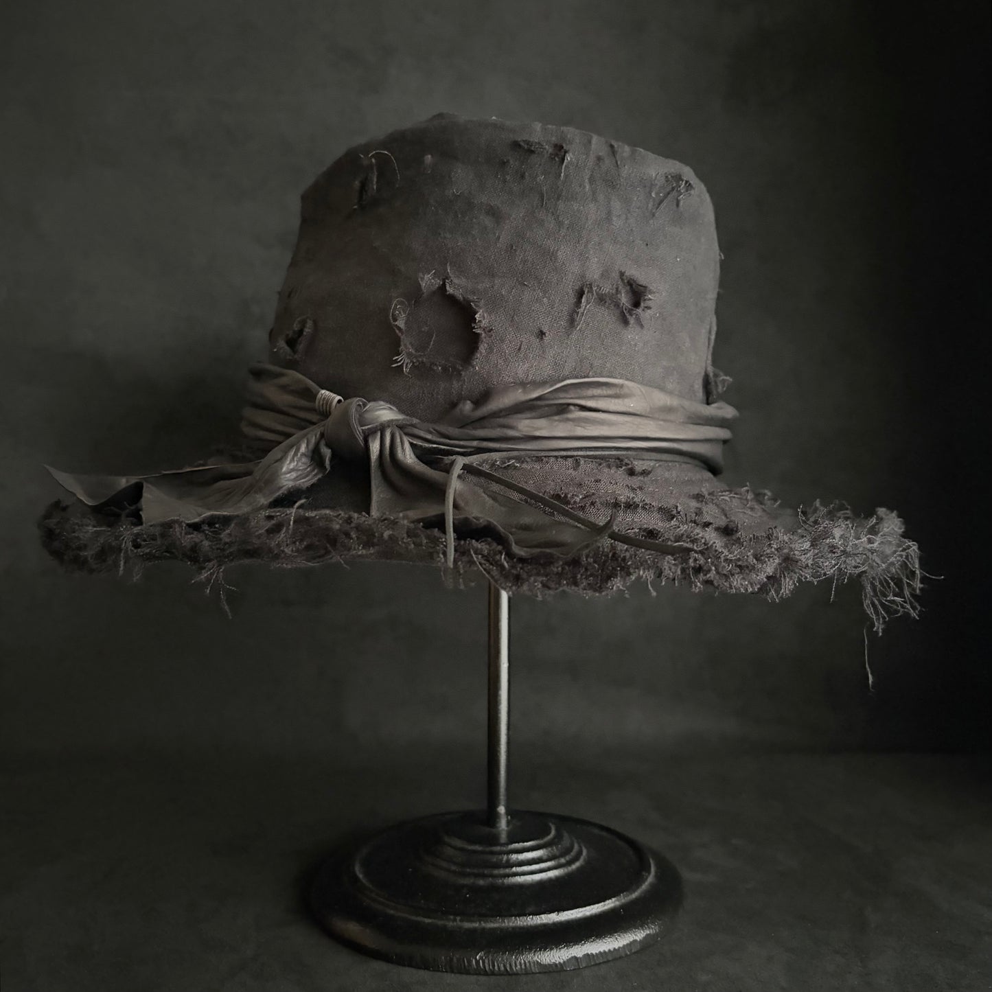 Black linen damage around fedora hat