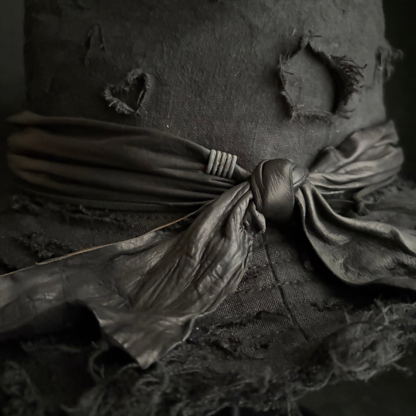 Black linen damage around fedora hat
