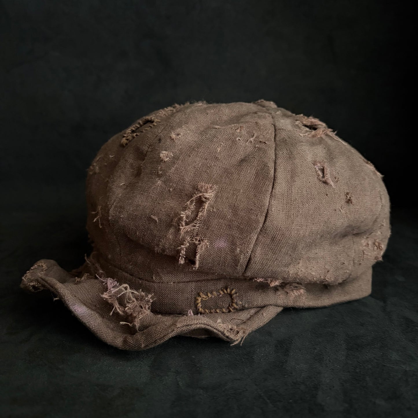 Brown linen damaged discolored casquette