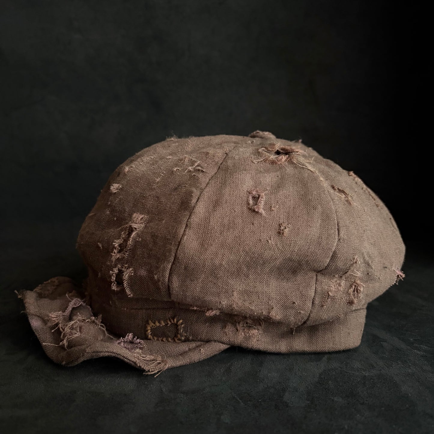 Brown linen damaged discolored casquette