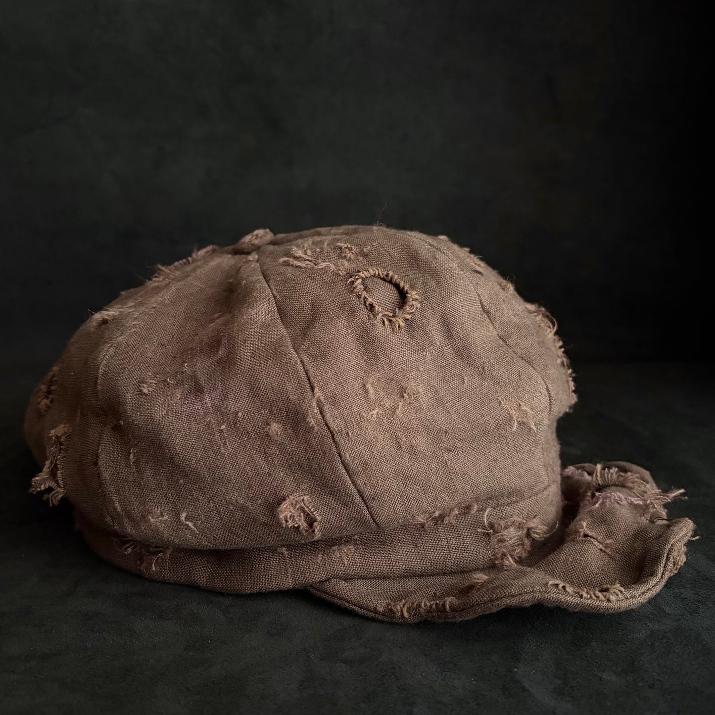 Brown linen damaged discolored casquette