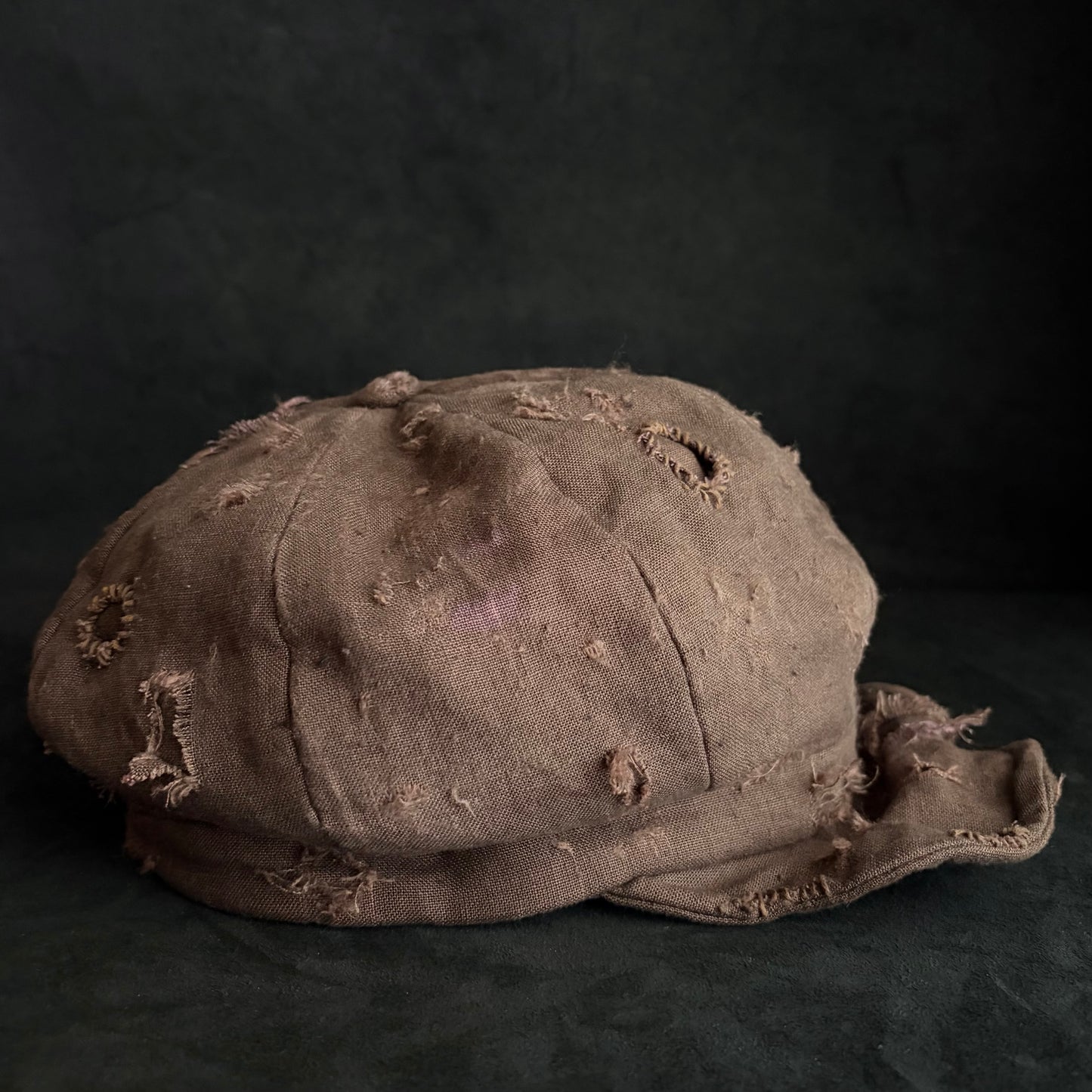 Brown linen damaged discolored casquette