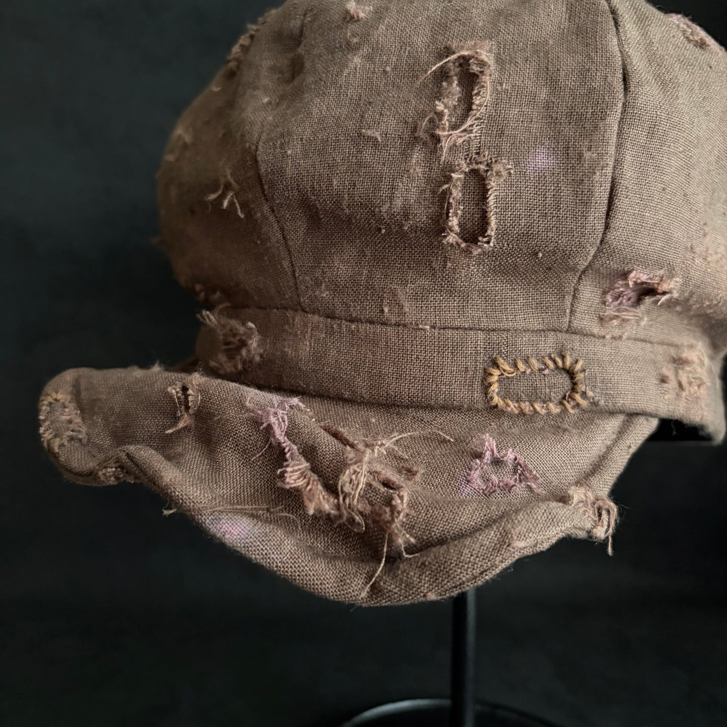Brown linen damaged discolored casquette