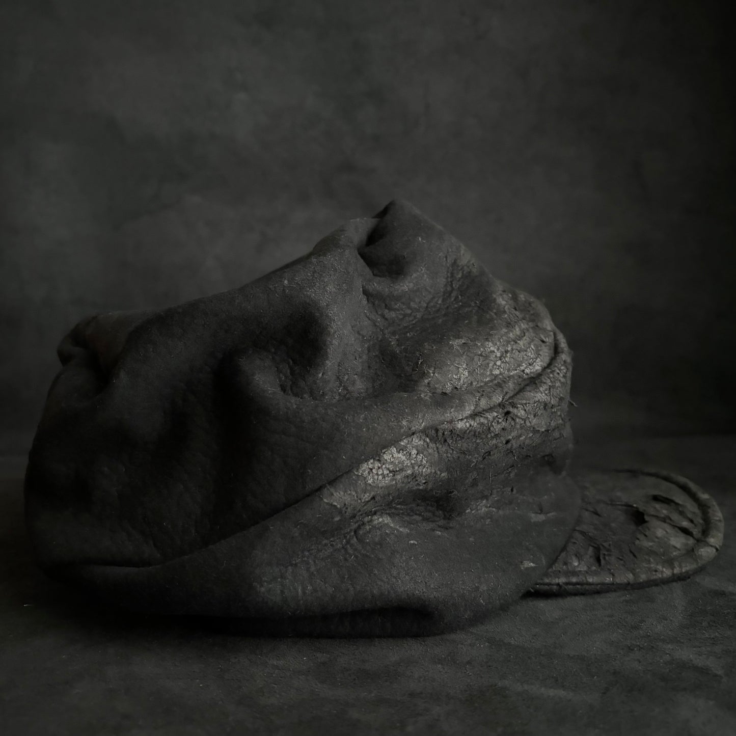 Floor under black leather turn cap (brim core)