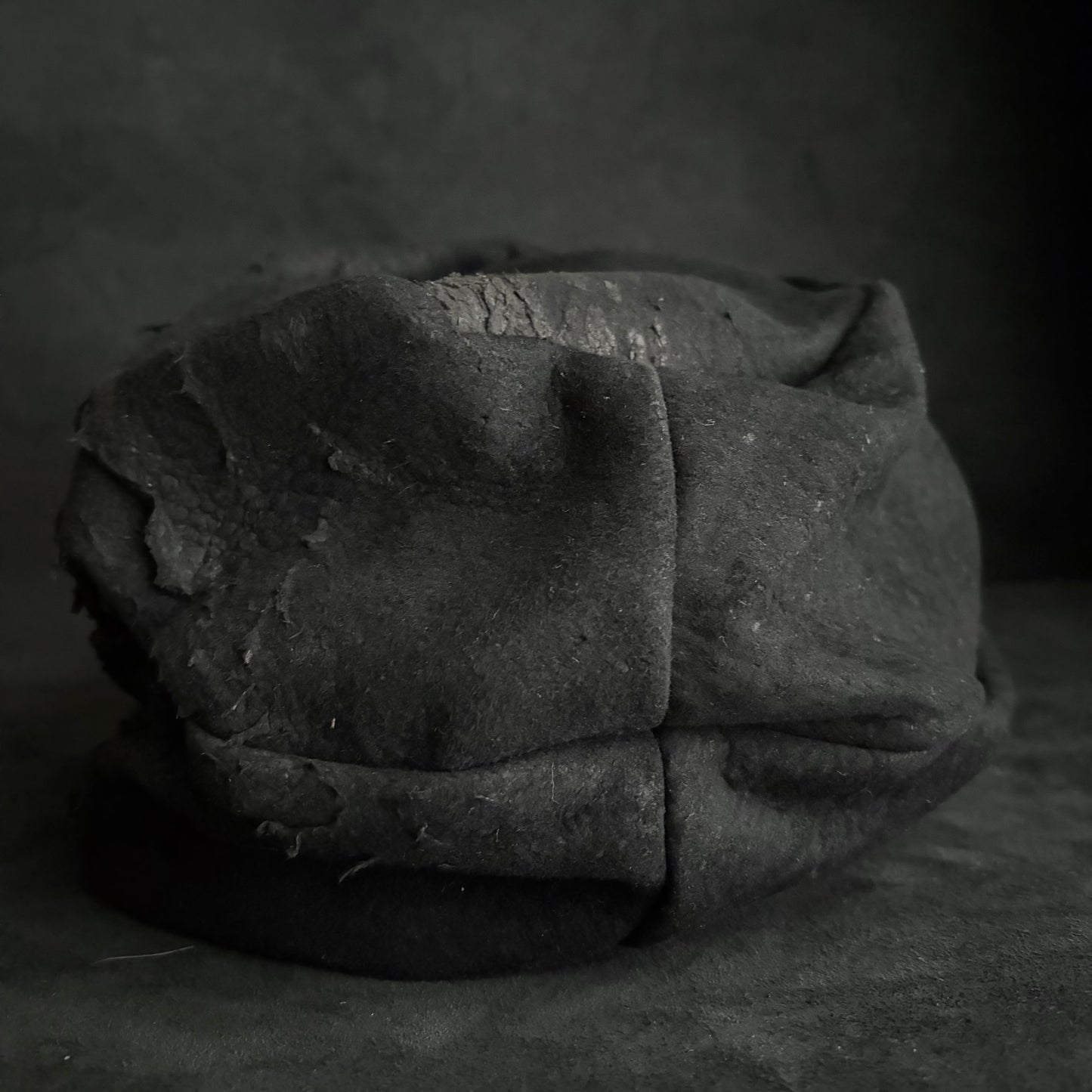 Floor under black leather turn cap (brim core)