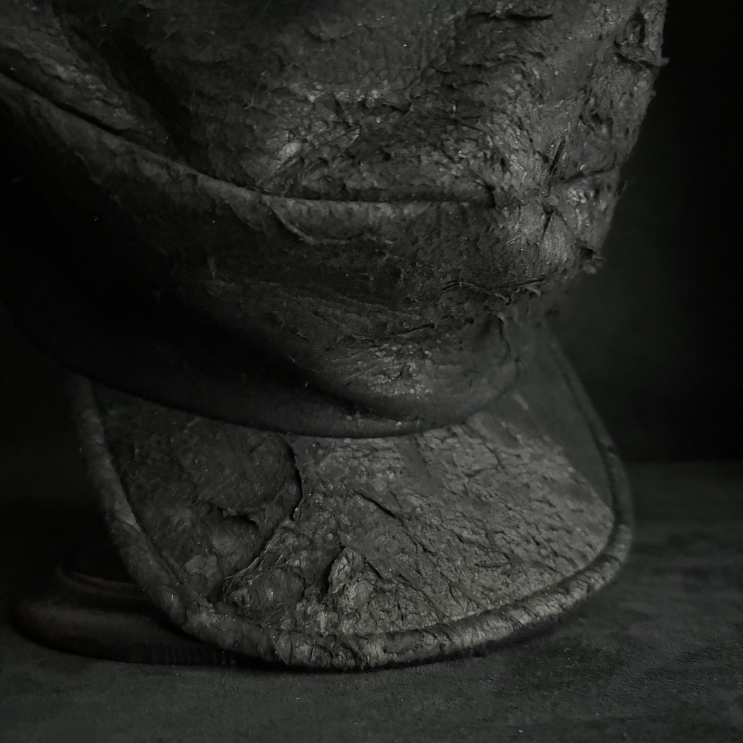 Floor under black leather turn cap (brim core)