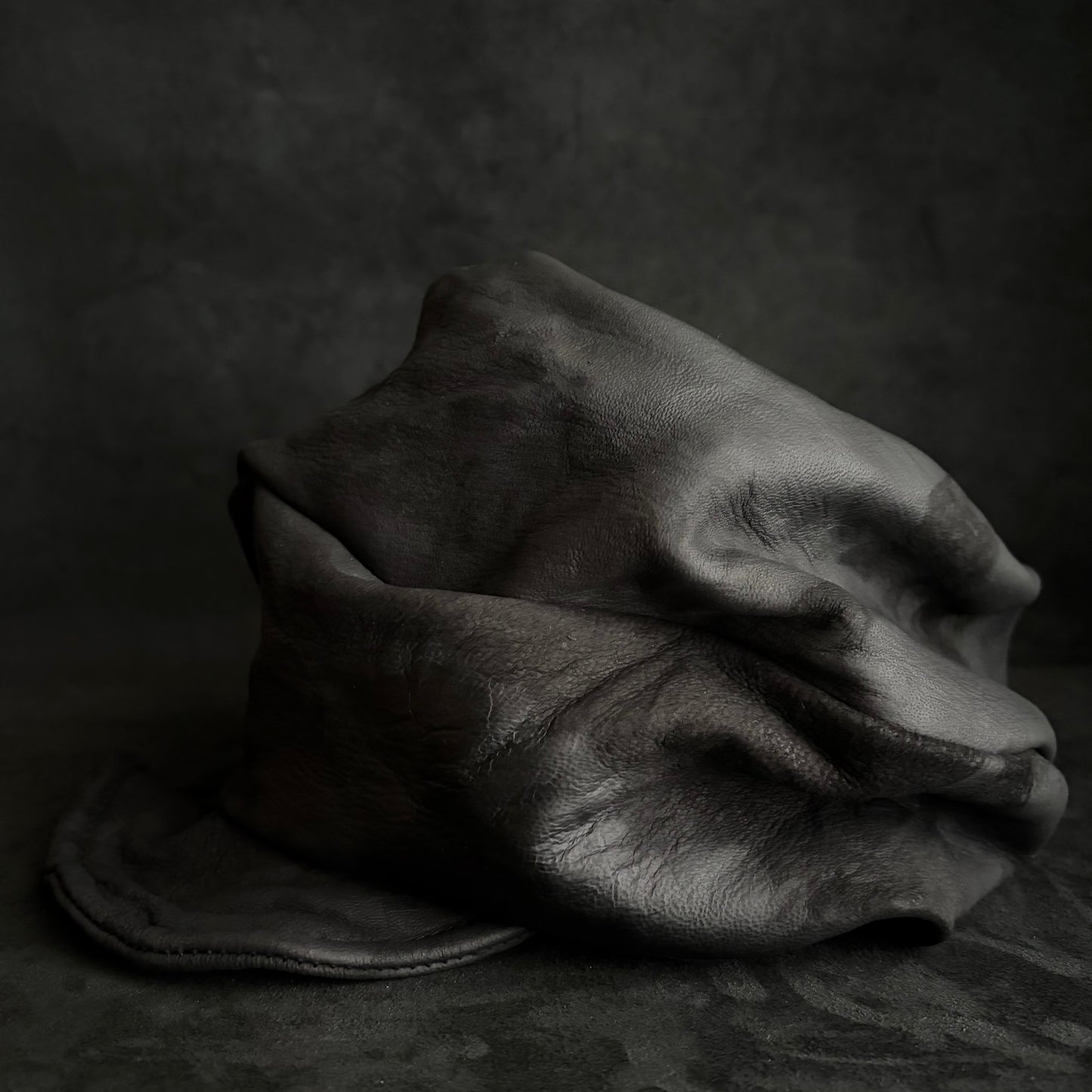 Bleached stable black leather turn cap