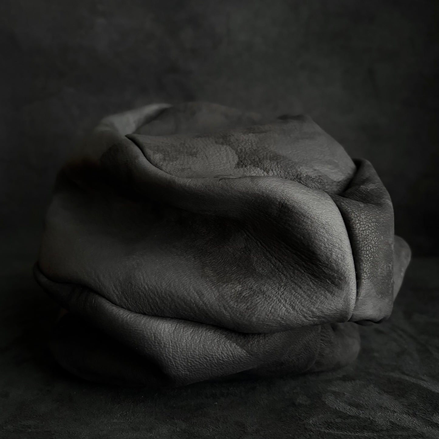 Bleached stable black leather turn cap