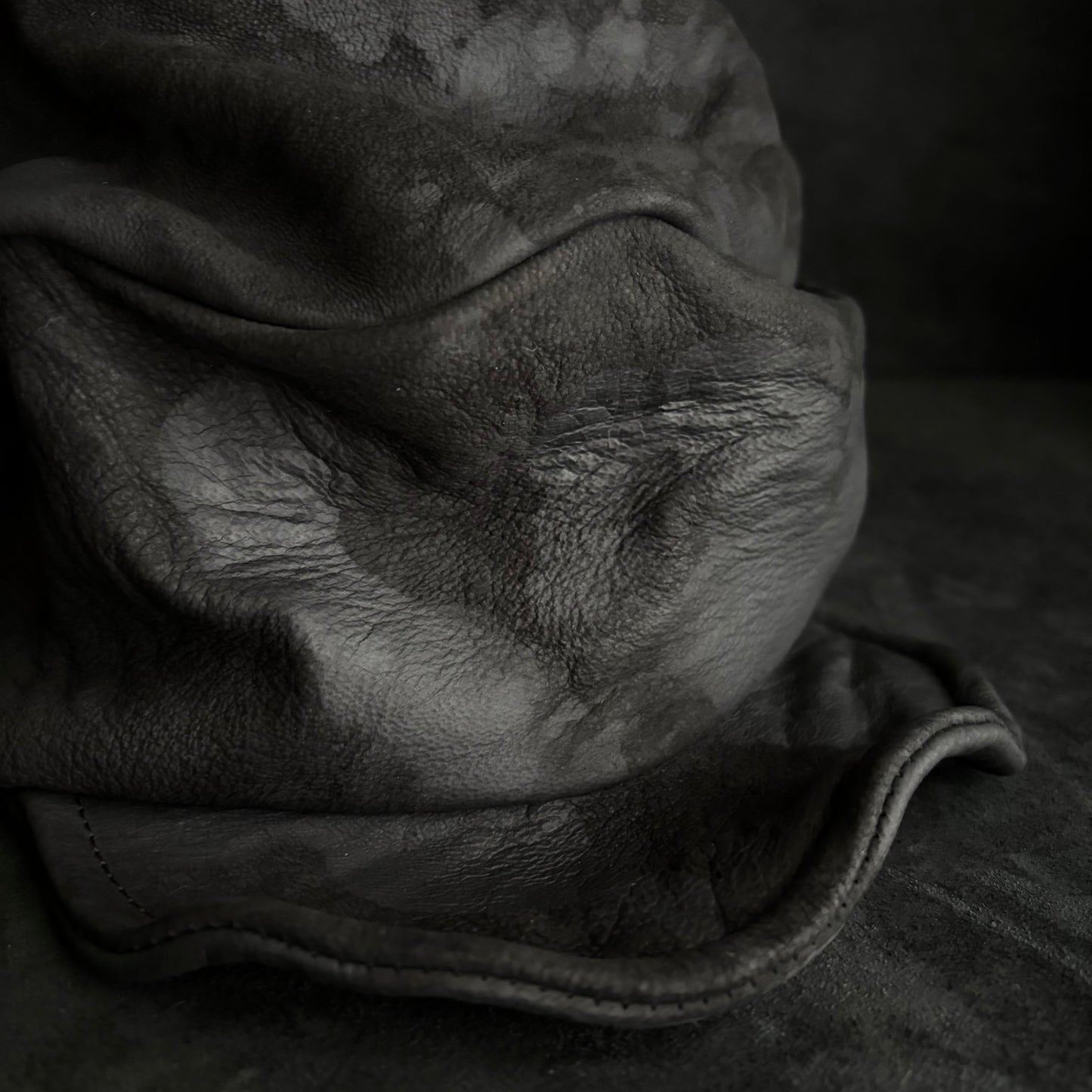 Bleached stable black leather turn cap