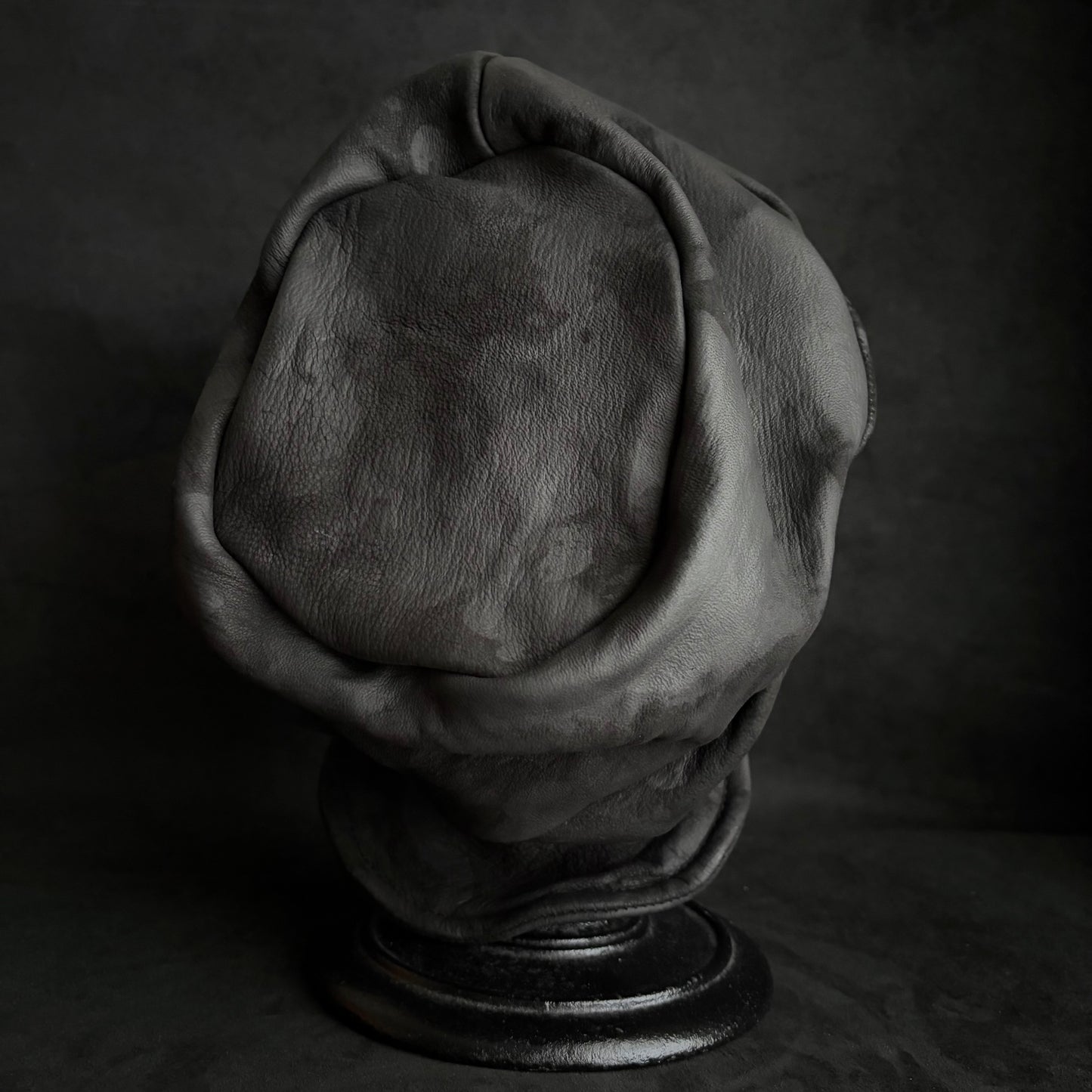 Bleached stable black leather turn cap