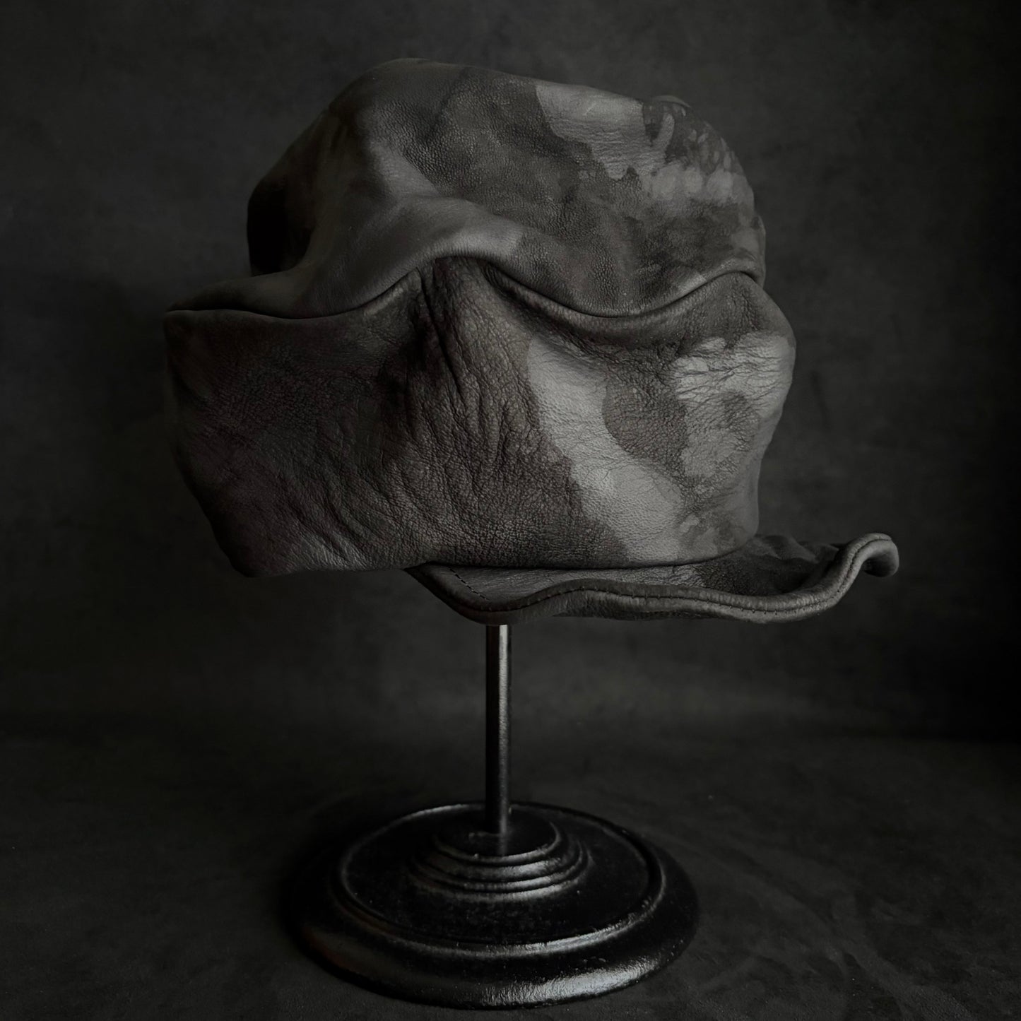 Bleached stable black leather turn cap