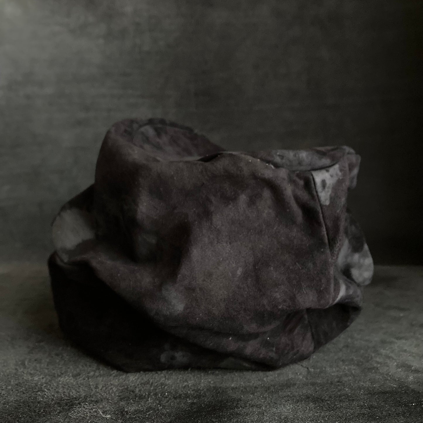 Bleached black leather turn cap