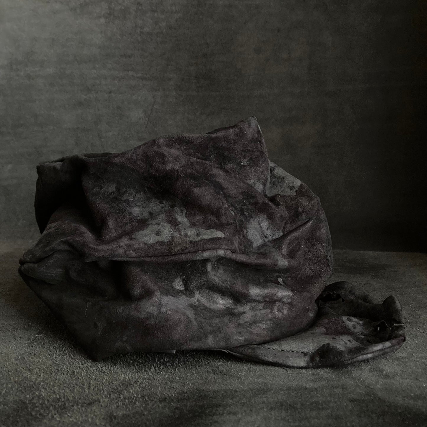 Bleached black leather turn cap