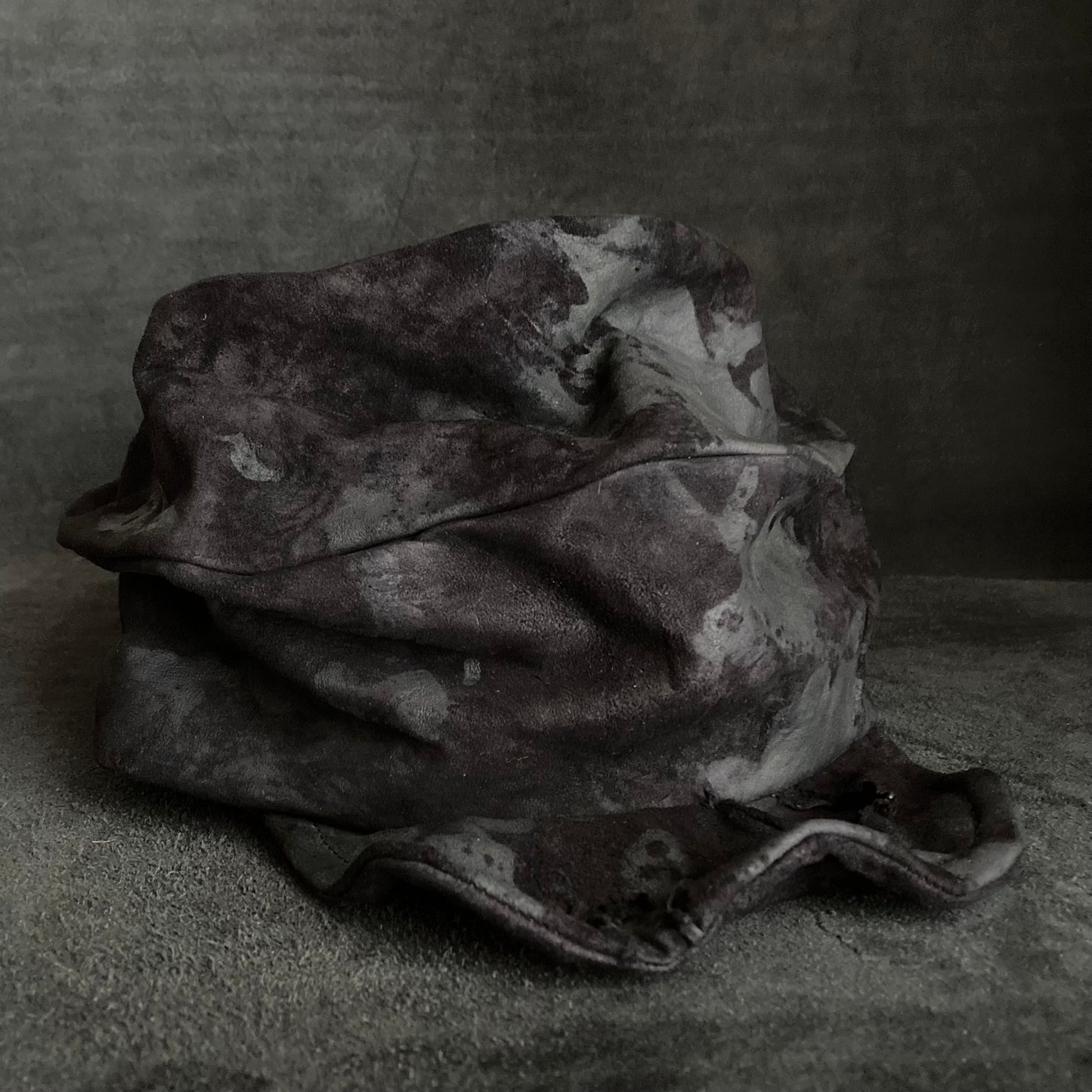 Bleached black leather turn cap