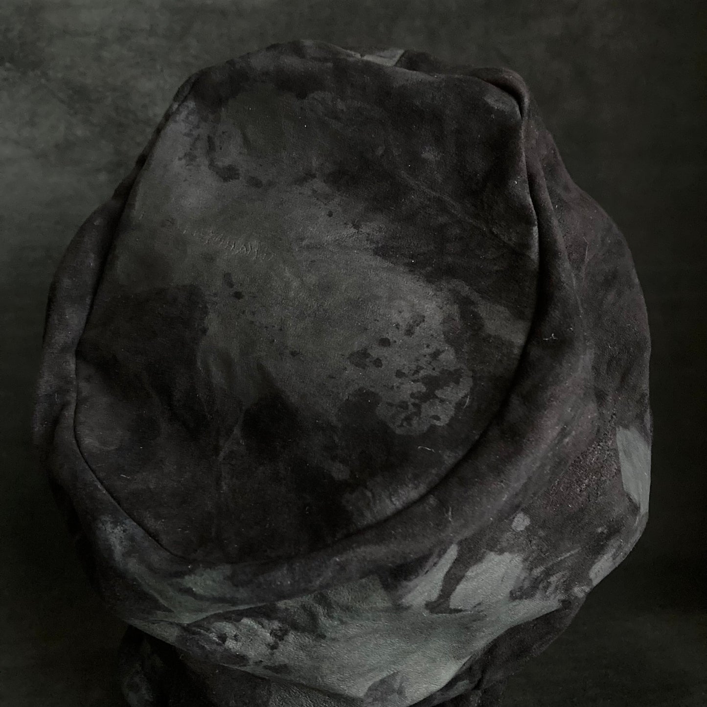 Bleached black leather turn cap