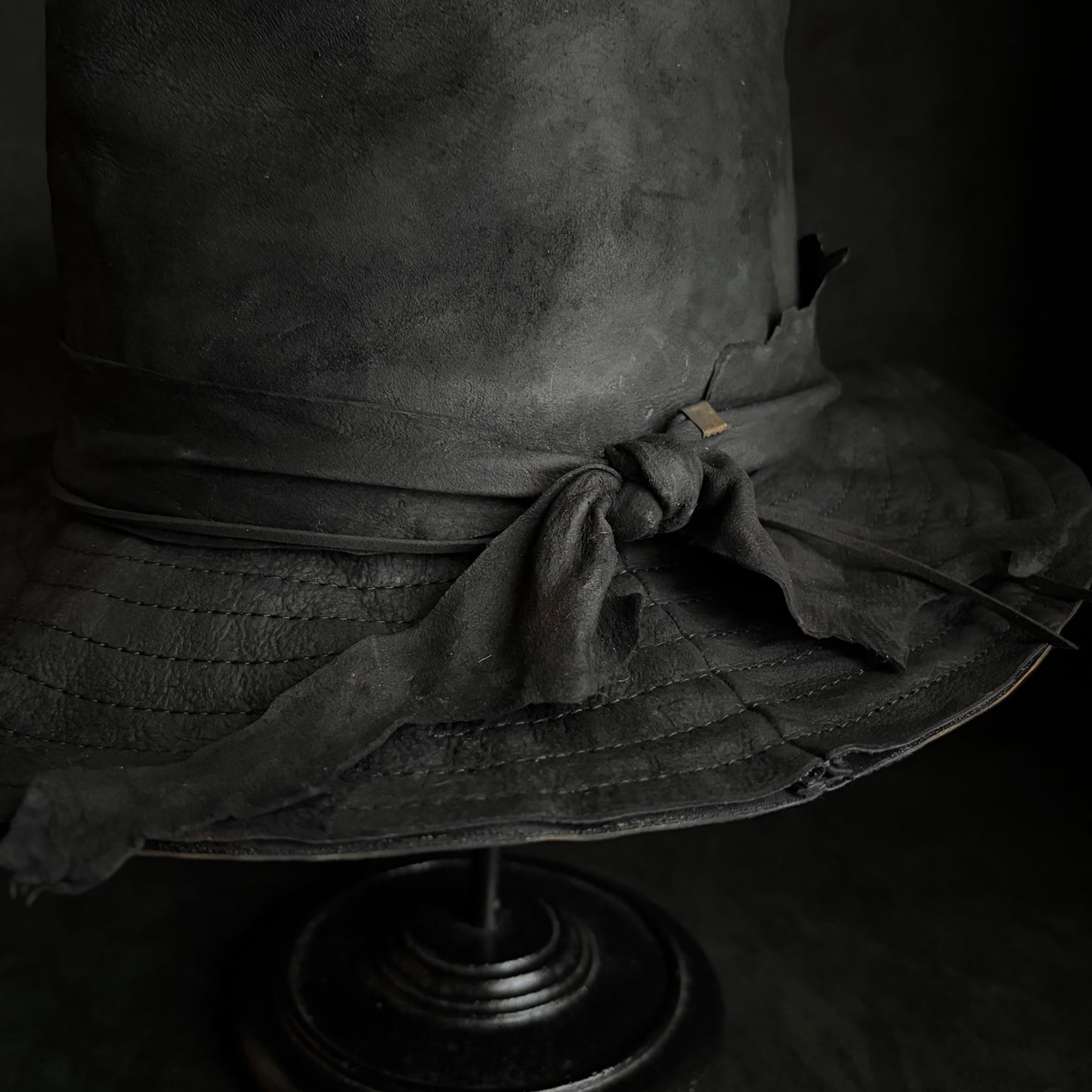 Faded black leather fedora hat