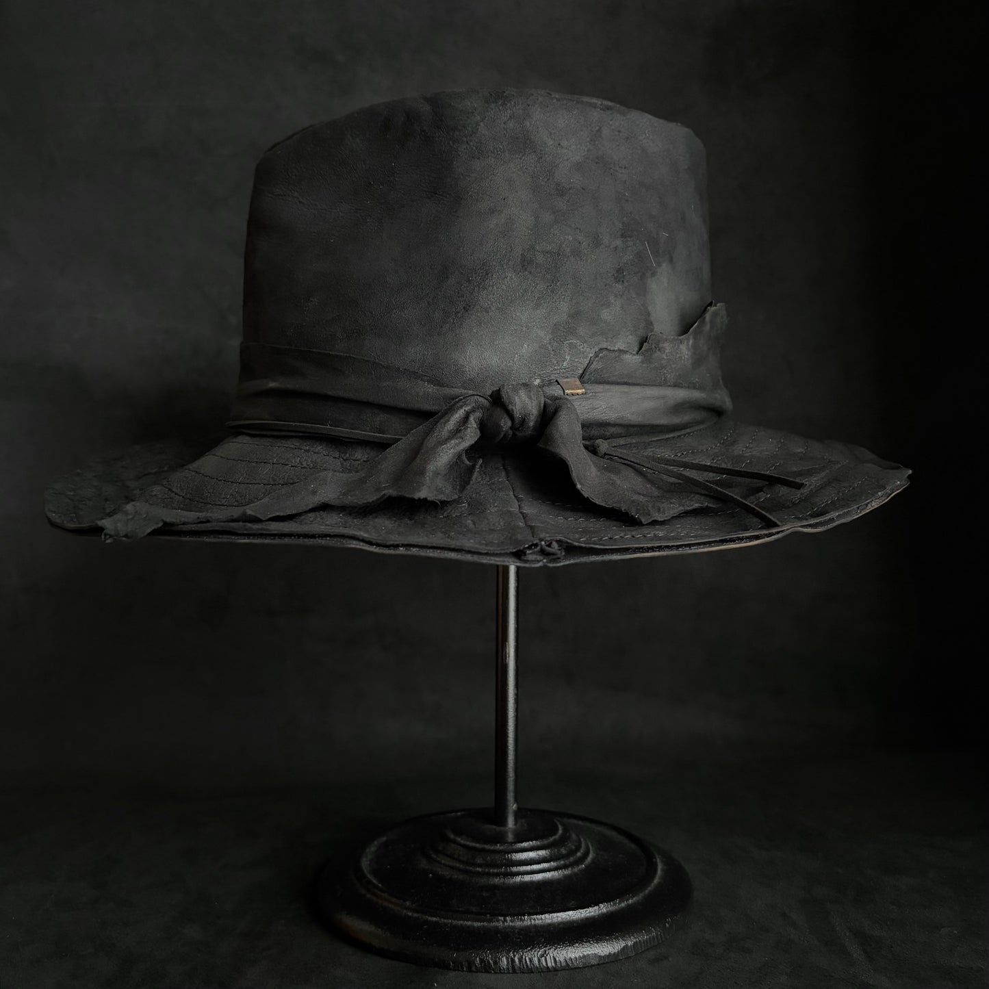 Faded black leather fedora hat