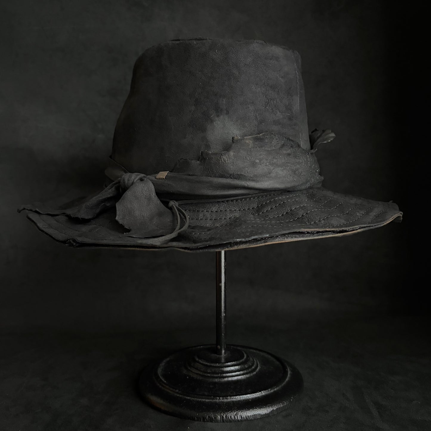 Faded black leather fedora hat