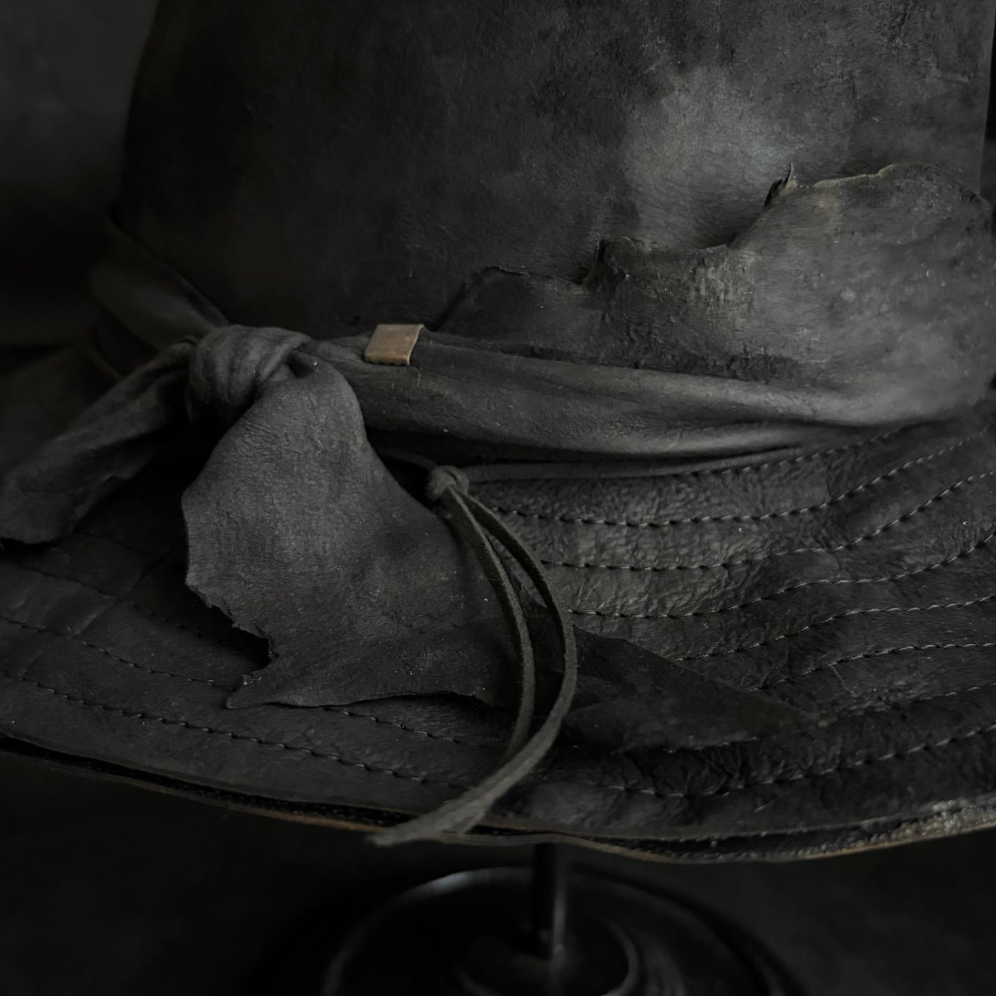 Faded black leather fedora hat