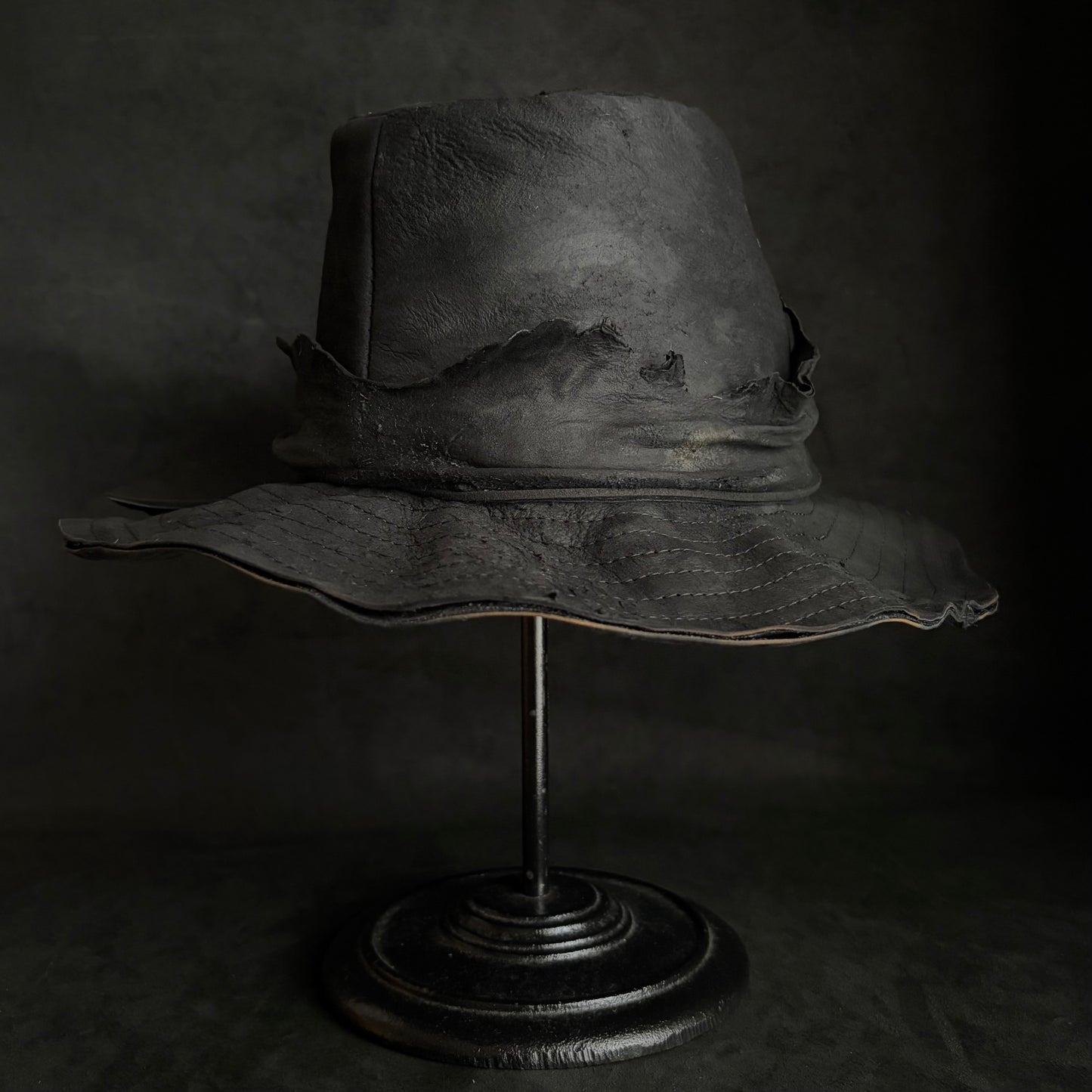 Faded black leather fedora hat