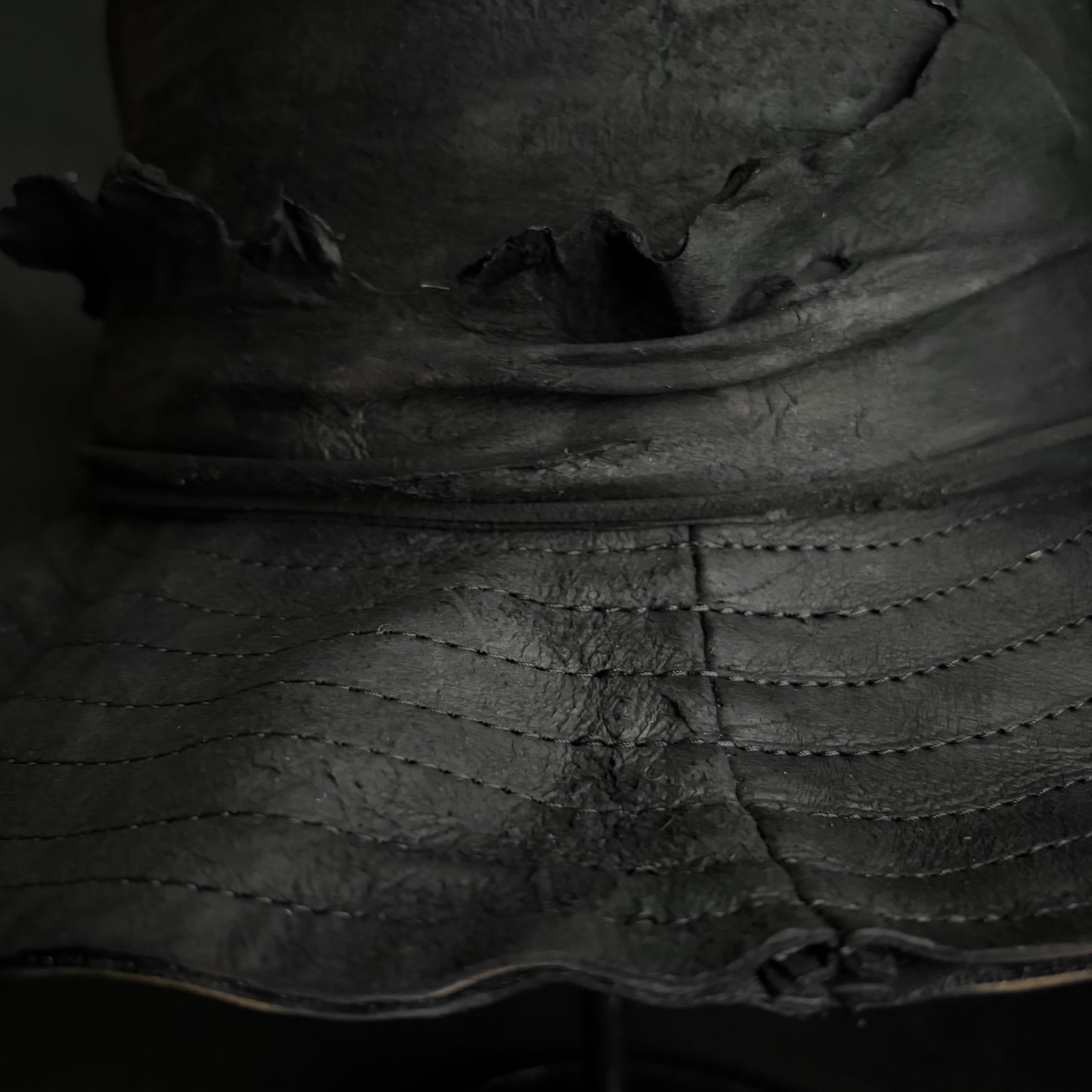 Faded black leather fedora hat