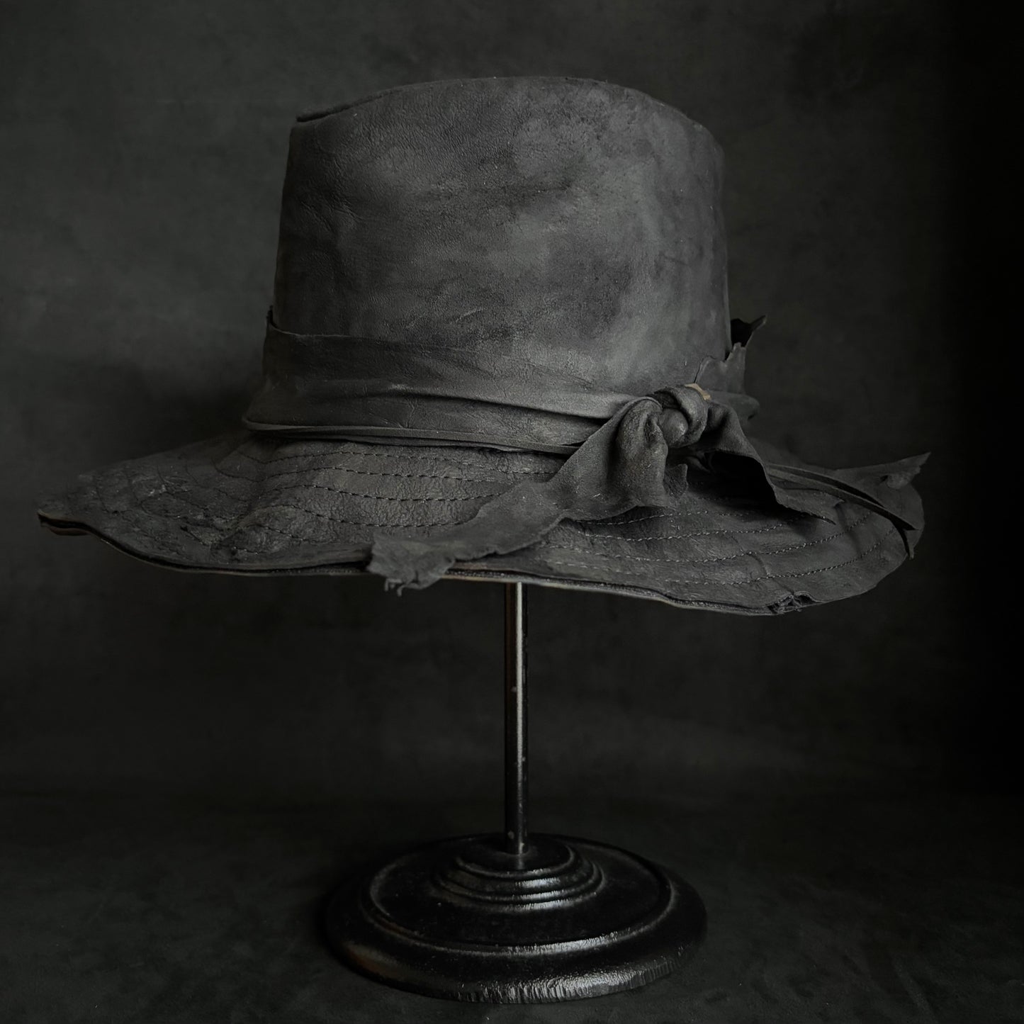Faded black leather fedora hat