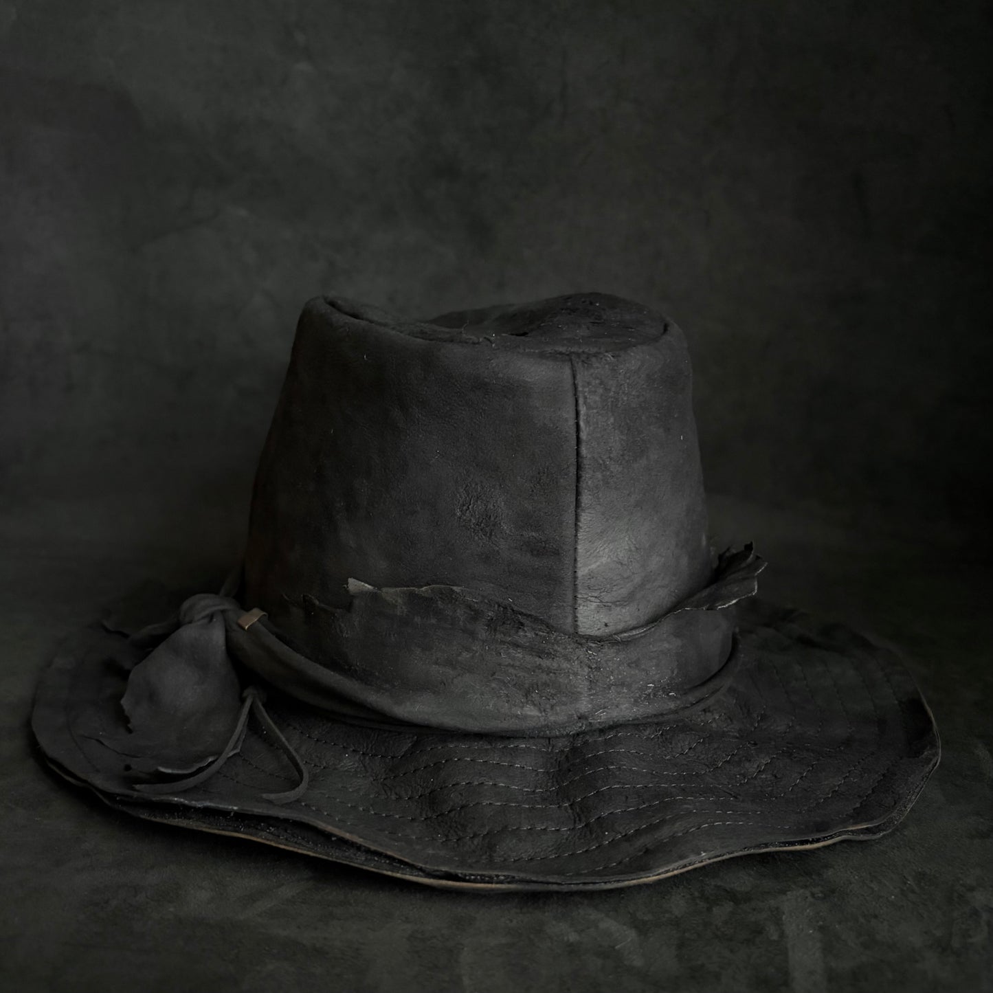Faded black leather fedora hat