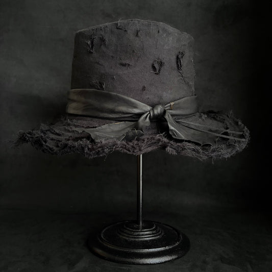 Black linen damage around fedora hat