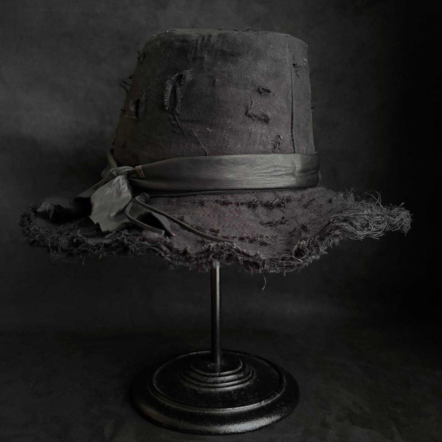 Black linen damage around fedora hat