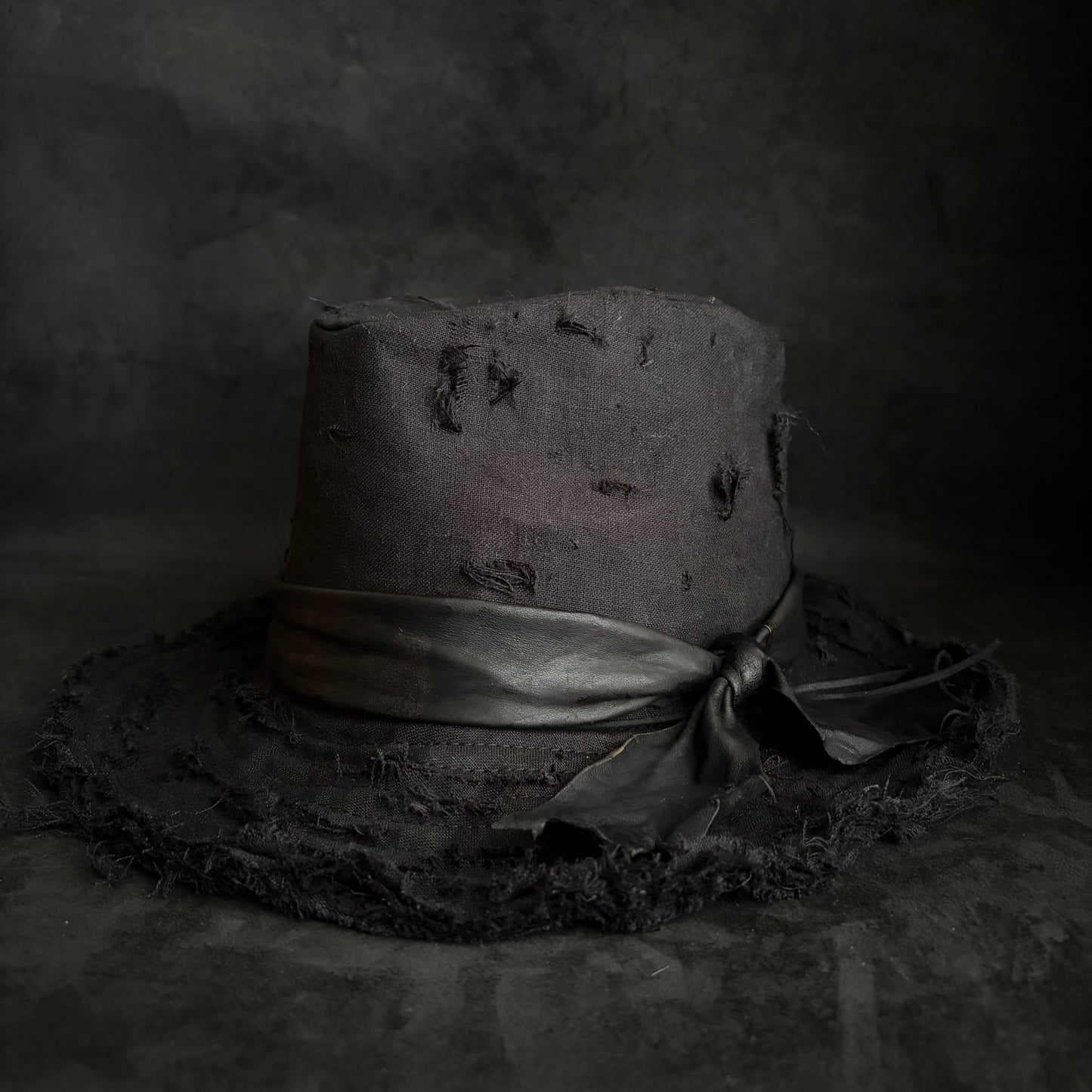 Black linen damage around fedora hat