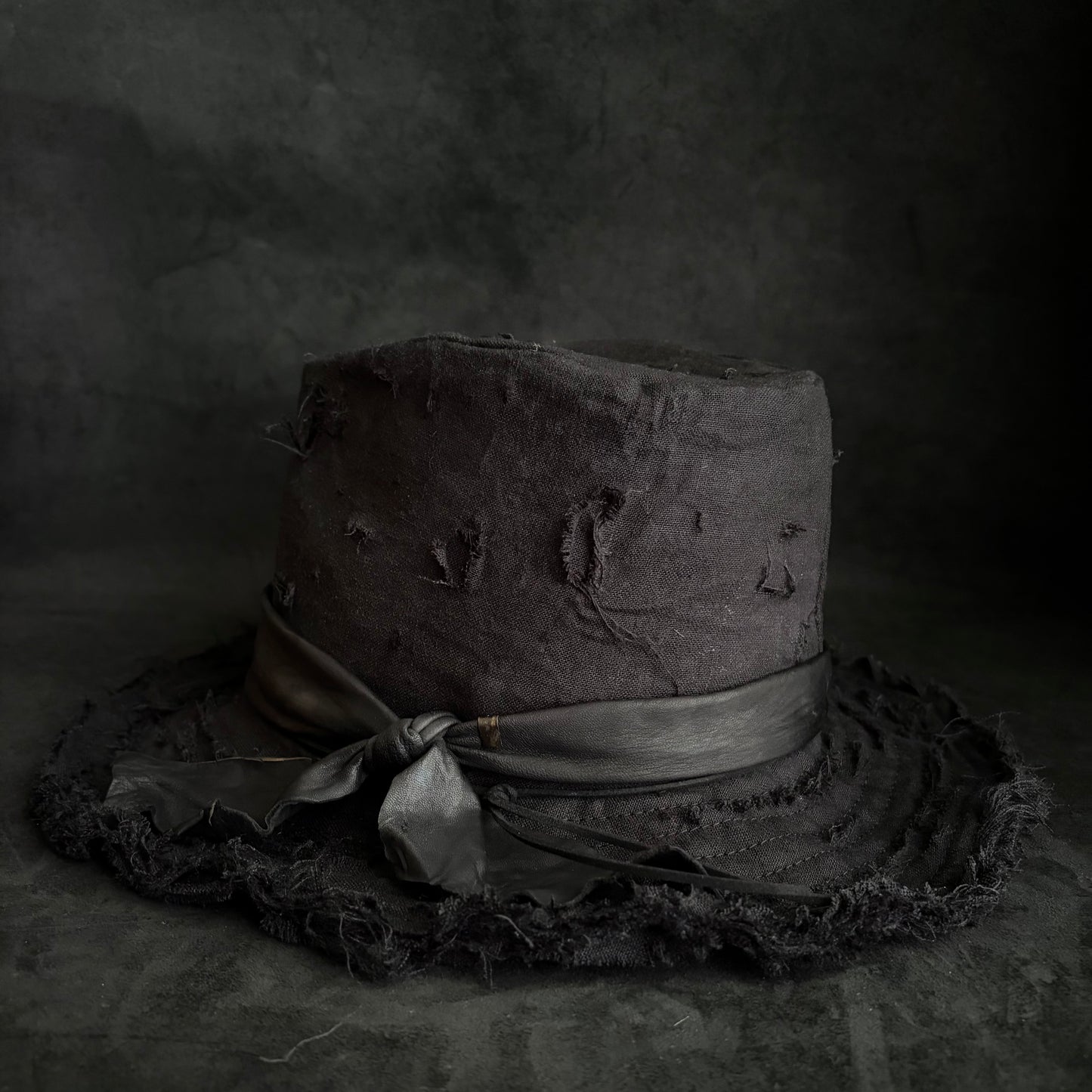 Black linen damage around fedora hat