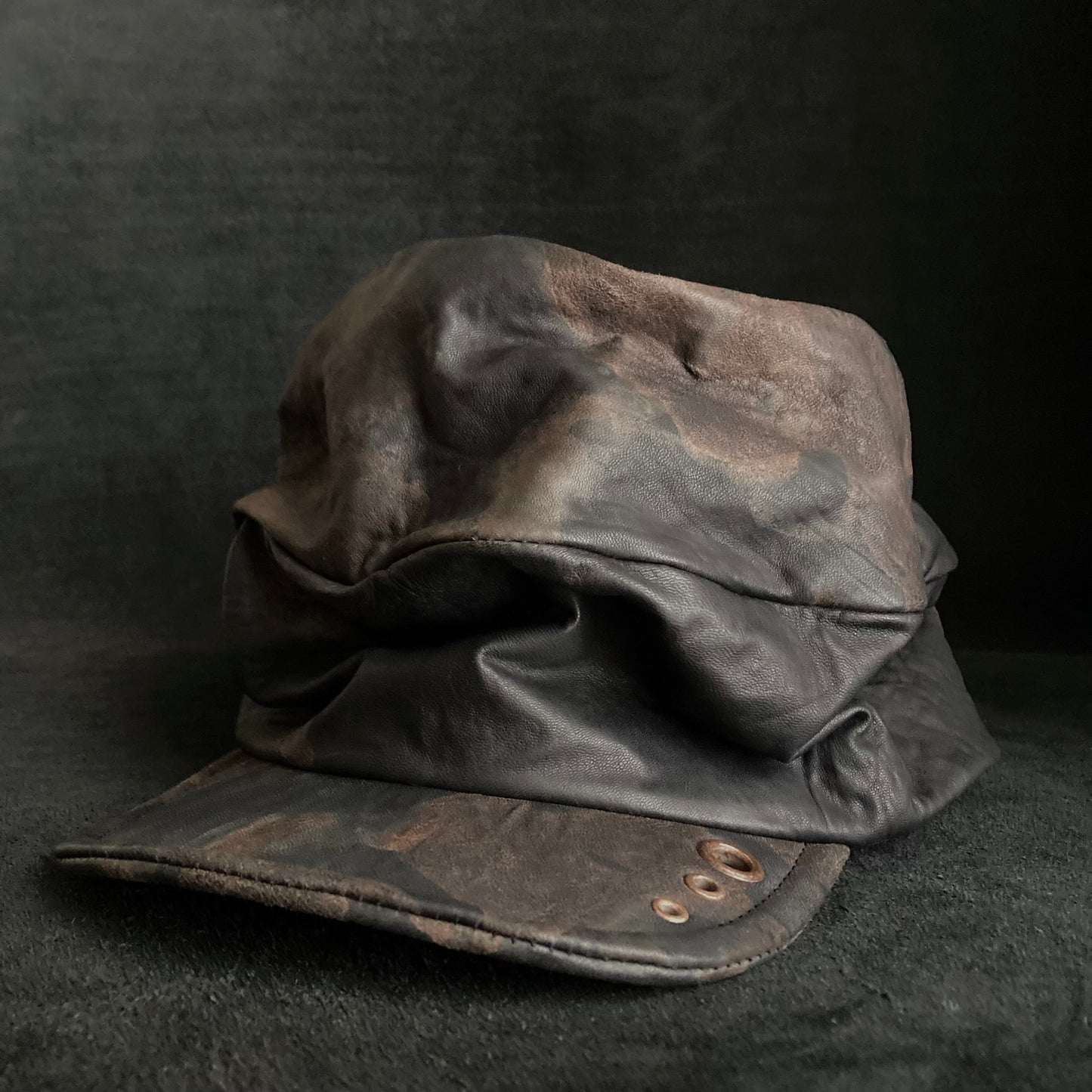 Discolored rusty leather turn cap