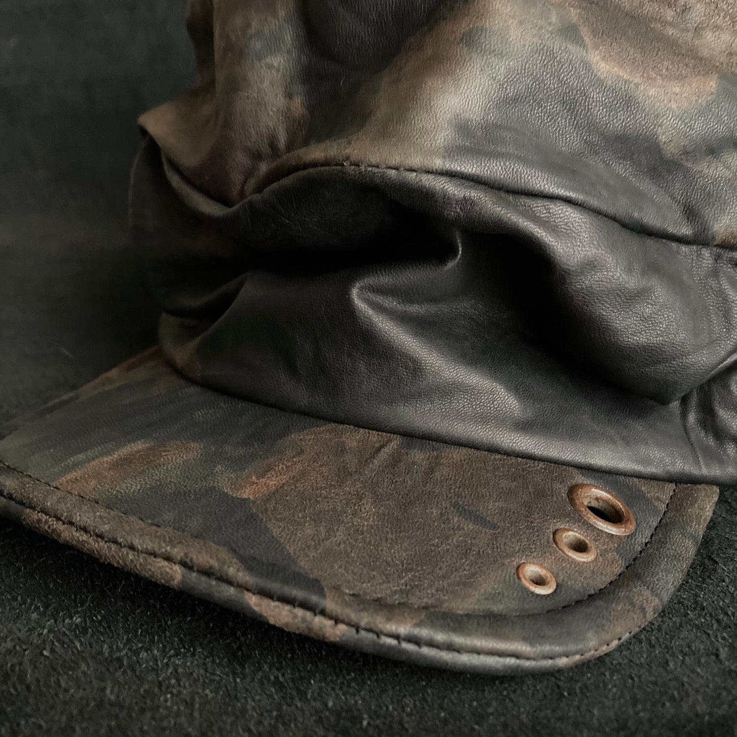 Discolored rusty leather turn cap