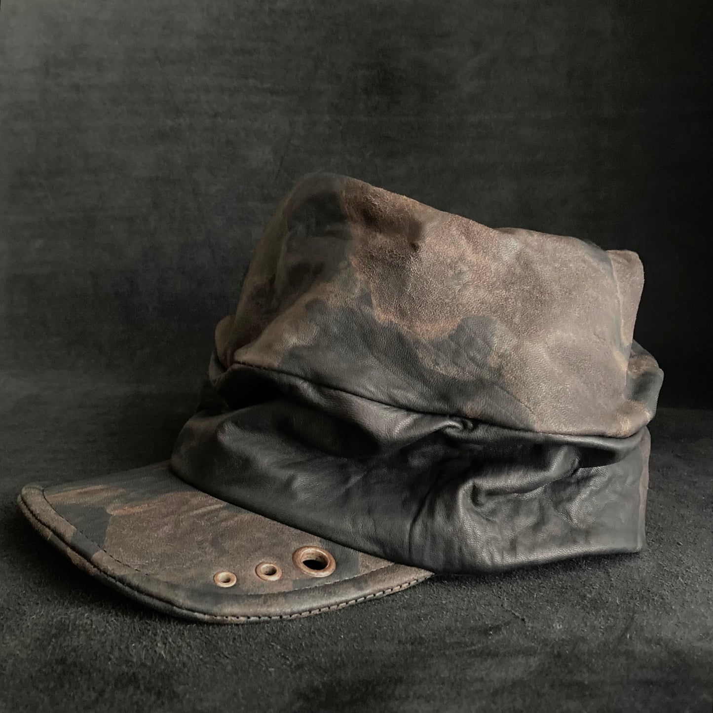 Discolored rusty leather turn cap