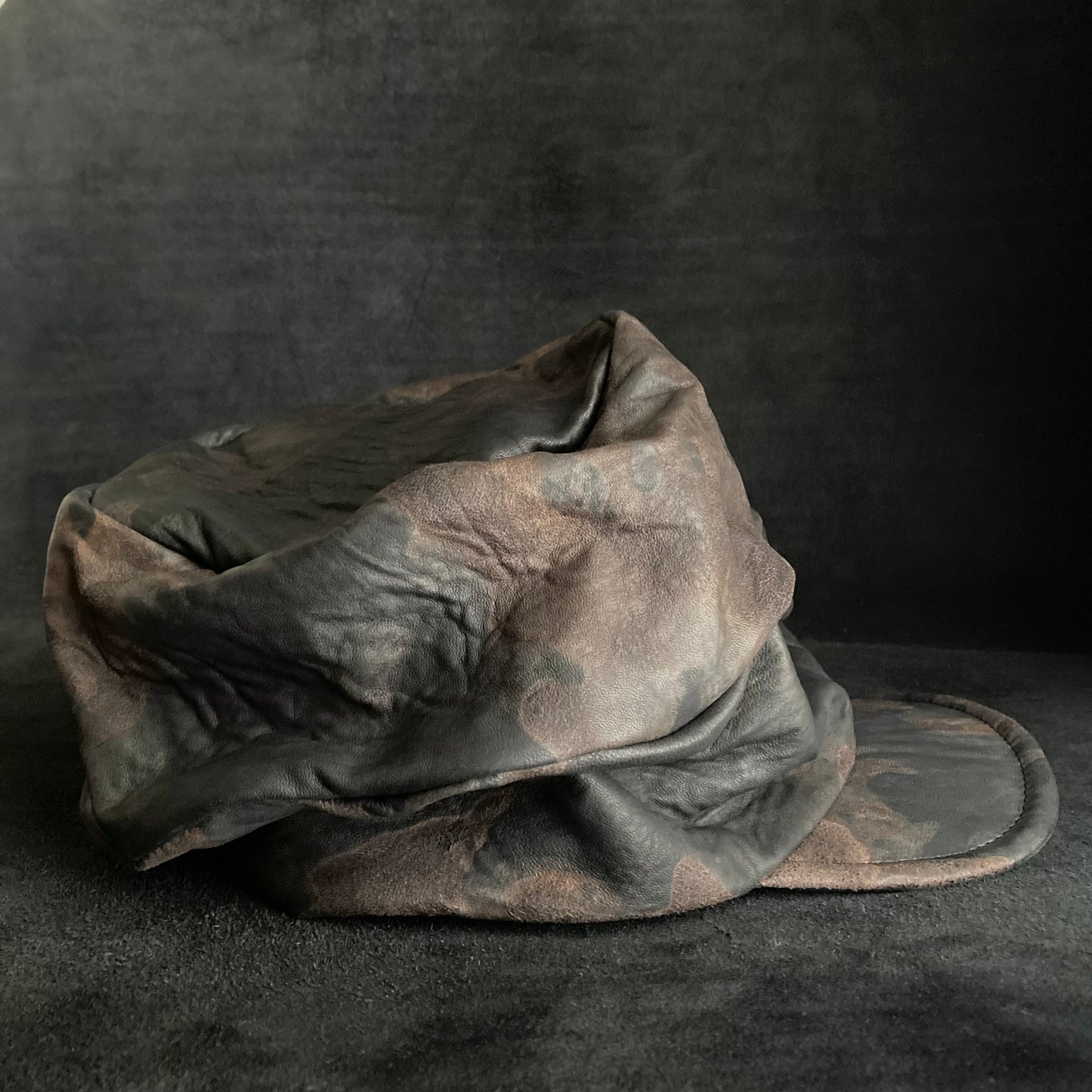 Discolored rusty leather turn cap