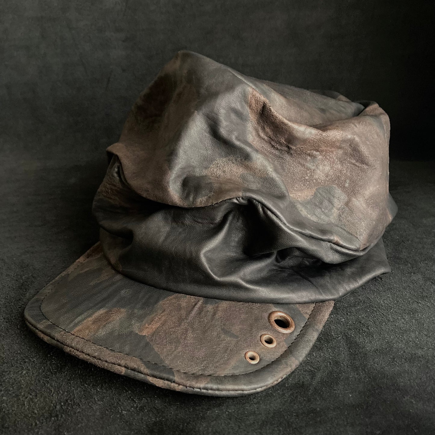 Discolored rusty leather turn cap