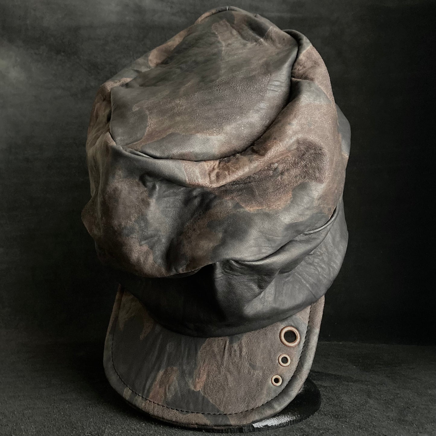 Discolored rusty leather turn cap