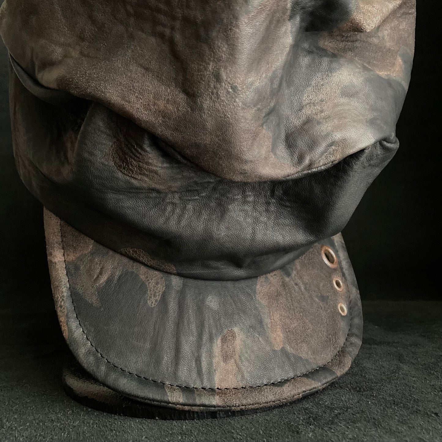 Discolored rusty leather turn cap