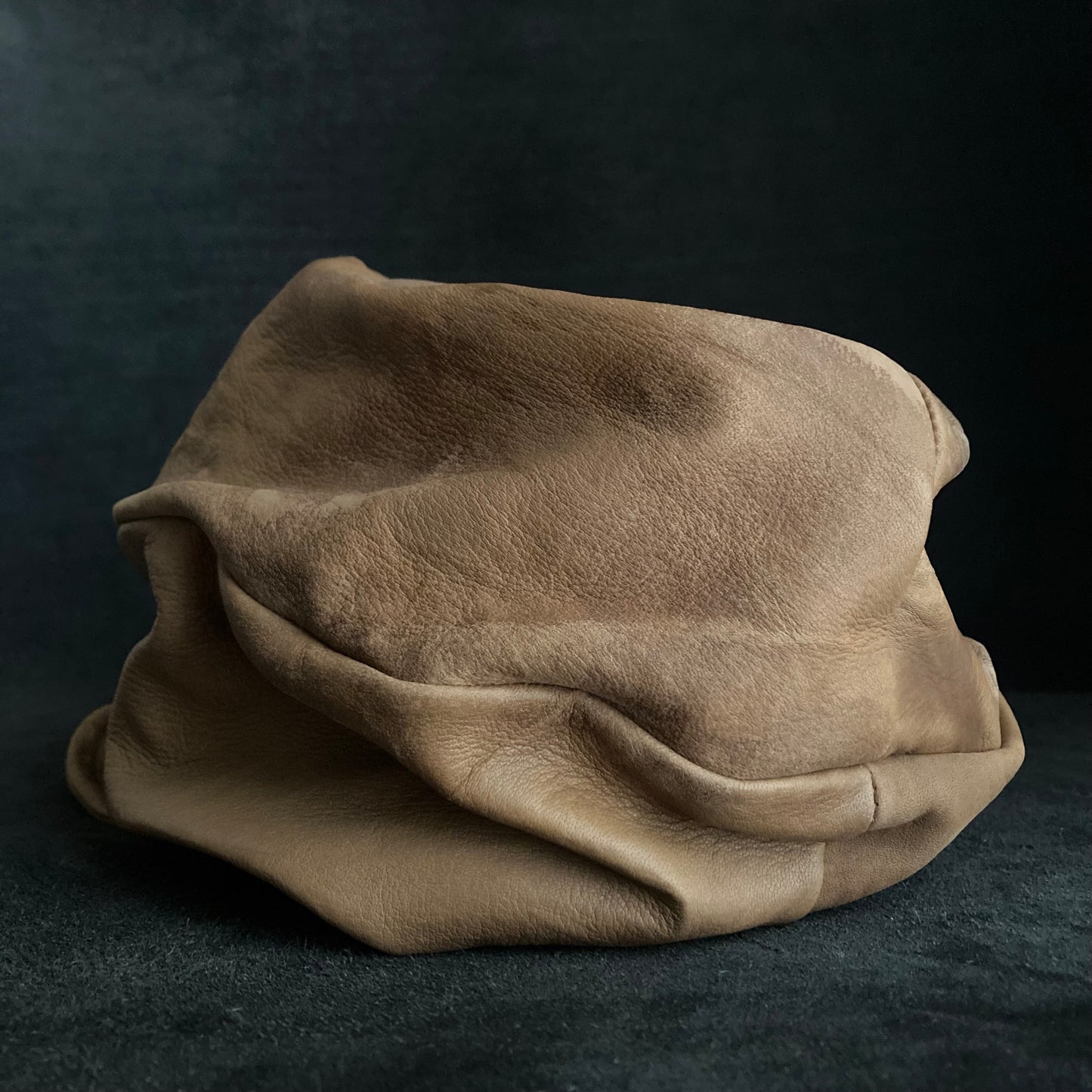 Irregularly dyed light brown leather turn cap