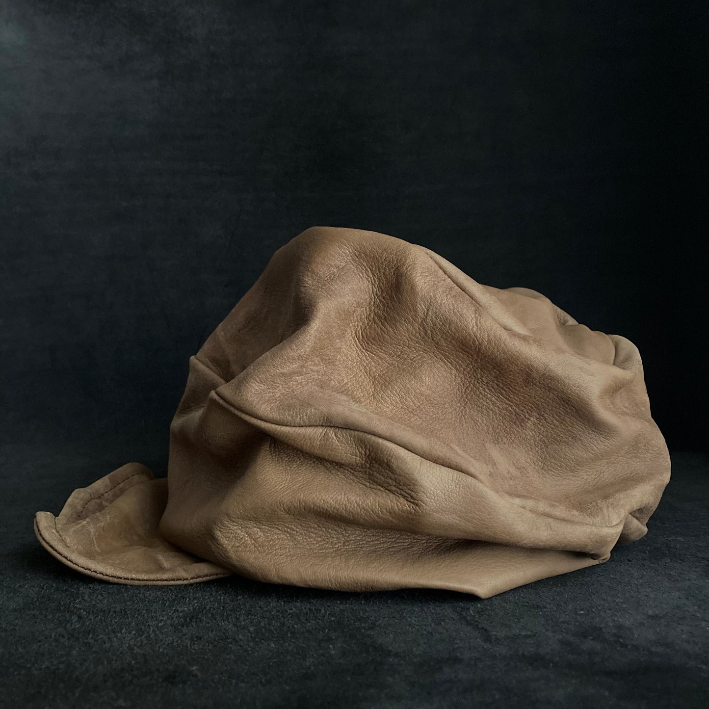 Irregularly dyed light brown leather turn cap